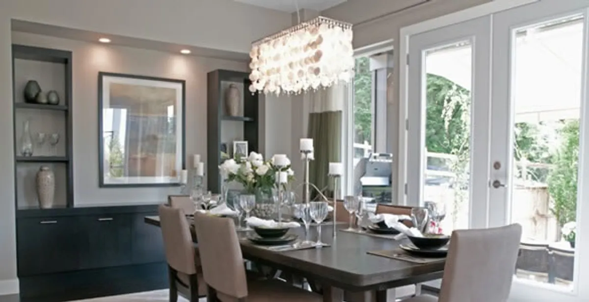 Elegant dining room chandelier installation above table in Aurora, CO