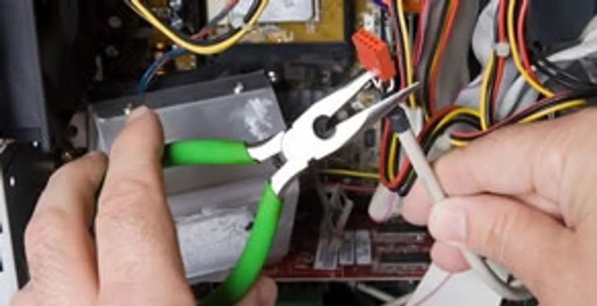 Licensed electrical contractor performing electrical repair with tools in Littleton, CO